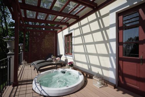 a jacuzzi tub sitting on a deck at Liepupe Manor in Liepupe