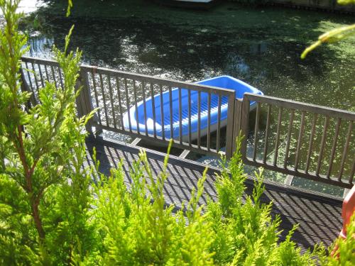a metal deck with a blue raft in the water at Quarenta Studio in Amsterdam