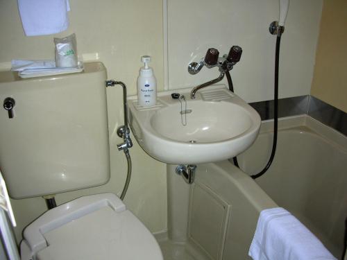 a small bathroom with a sink and a toilet at Hotel A.P in Toyonaka