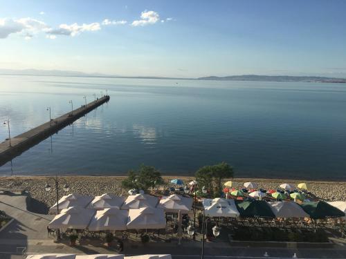 a view of a beach with a pier and water at Vento di Mare in Perea
