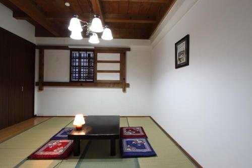 a room with a table and mats on the floor at Hakodate Motomachi Hotel in Hakodate