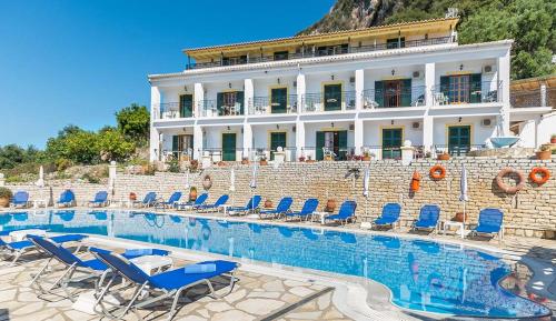 a resort with chairs and a swimming pool at Captain Spiros Studios in Paleokastritsa