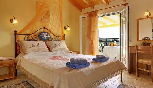 a bedroom with a large bed with towels on it at Captain Spiros Studios in Paleokastritsa