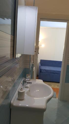 a bathroom with a white sink and a mirror at Acquamarina Accommodation in Massa Lubrense