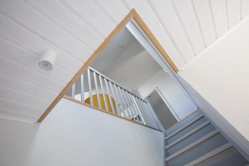 a spiral staircase with a stair case in a house at Haapsalu Old Town Apartments in Haapsalu