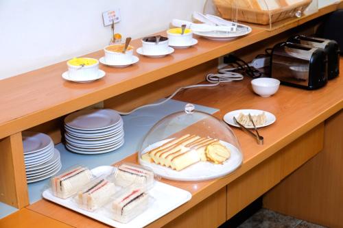 a buffet with plates and dishes on a table at Summer House Motel in Tainan