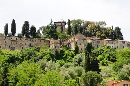 an old castle on top of a hill with trees at Agriturismo Chieteno con piscina e AC- Cetona in Cetona
