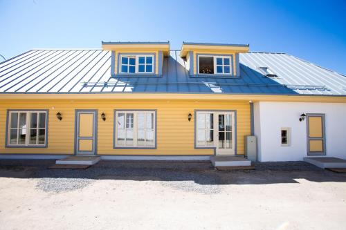 a yellow house with a blue roof at Haapsalu Old Town Apartments in Haapsalu