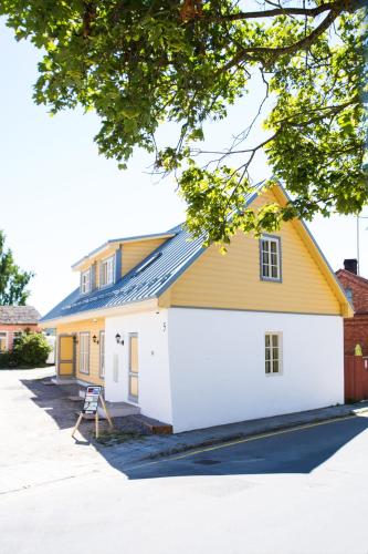 a white and yellow house with a yellow roof at Haapsalu Old Town Apartments in Haapsalu