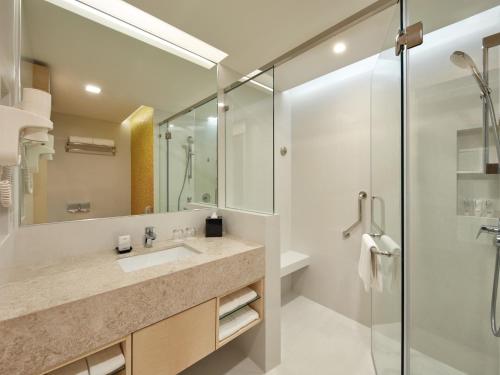 a bathroom with a sink and a glass shower at Sunway Pyramid Hotel in Kuala Lumpur