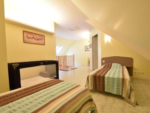 a bedroom with two beds in a room at Family Stay in Normandy in Villedieu-les-Poëles
