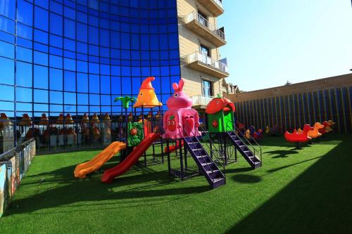 a childrens playground with a slide and a play structure at Spring Hotel in Novxanı