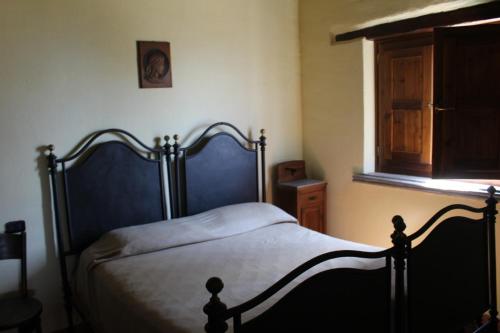 a bedroom with a bed and a window at Casetta ai Malvitani in Cetraro