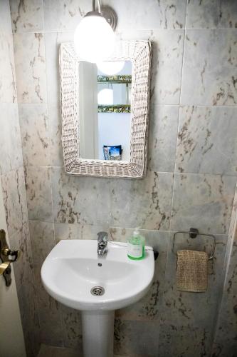 a bathroom with a sink and a mirror at Duplex 2 bedrooms for you with Air Conditioner in Palm-Mar