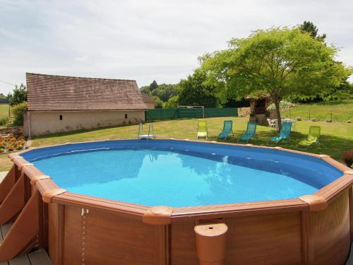 a large swimming pool in a yard at Beautiful holiday home near lake and forest in Payzac