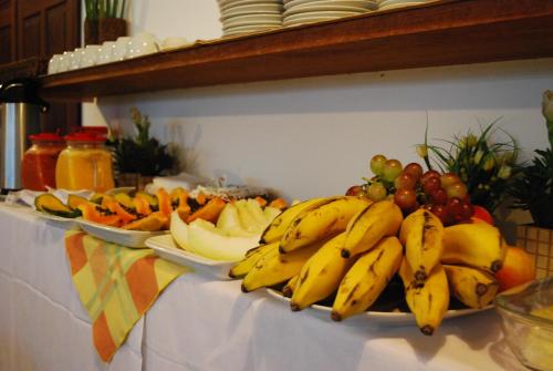 a bunch of bananas and other fruits on a table at Pousada Canto do Rio in Prado