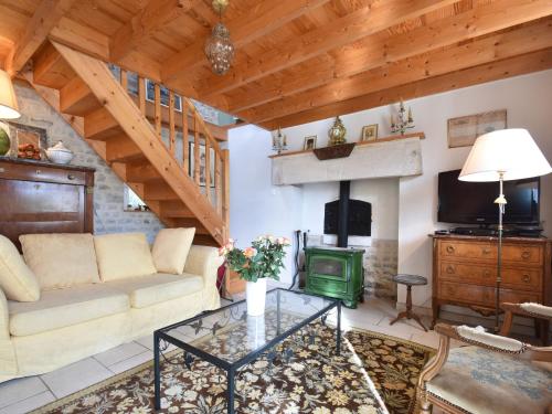 sala de estar con sofá y chimenea en Cozy Cottage in Fresville with Garden en Fresville