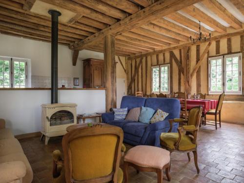 a living room with a blue couch and a fireplace at Holiday home with private terrace in Saint-Aignan