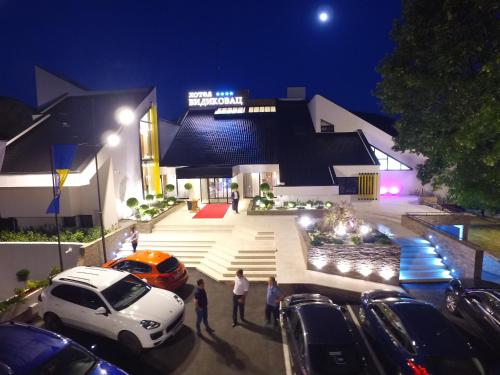 a group of people standing outside of a building at night at Hotel Vidikovac in Zvornik