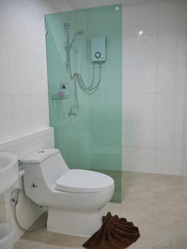 a bathroom with a shower with a toilet and a sink at Marisa Garden Bungalow in Bang Tao Beach