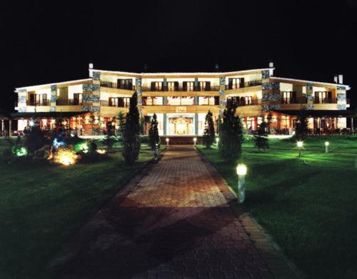 a large building is lit up at night at Le Chalet in Xanthi
