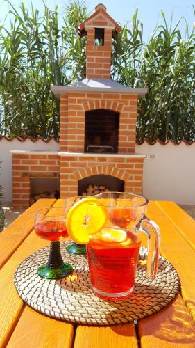 a table with two drinks in front of a fireplace at Casa Susanna in Kaštelir