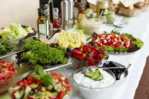 a buffet with many different types of food on a table at Hotel El Greco in Rožnov pod Radhoštěm