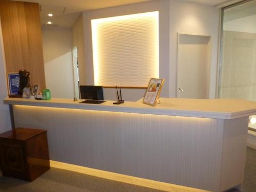 a reception counter in a office with a window at Hotel Hanakomichi in Nara