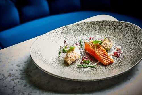 a plate with some food on a table at Apex City Of London Hotel in London