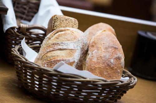 a wooden table topped with a basket filled with bread at Thon PartnerHotel Skagen in Bodø