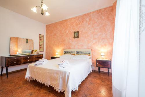 a bedroom with a bed and two dressers and a mirror at Impronta di Gaia in Foiano della Chiana