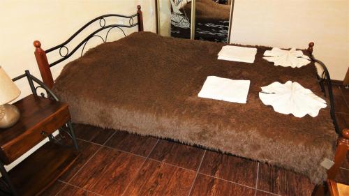 a bed with two towels on top of it at Villa Sosnovy Bor in Zatoka