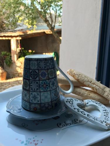 a blue and white coffee cup sitting on a table at Vesta in Sorgono