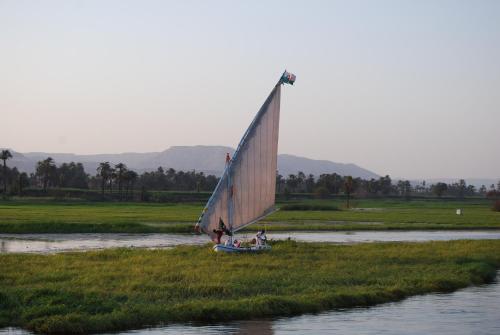 a group of people on a sail boat on a river at Rezeiky Hotel & Camp in Luxor