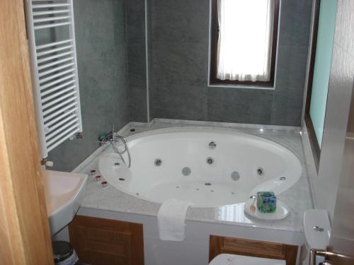 a bathroom with a bath tub and a sink at Posada la Desmera in Isla