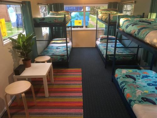 a room with several bunk beds in a train at Skye Backpackers in Kyleakin