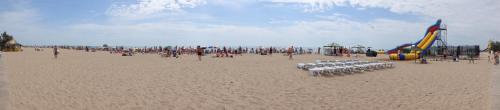 a large group of people on a beach at Villa Sosnovy Bor in Zatoka