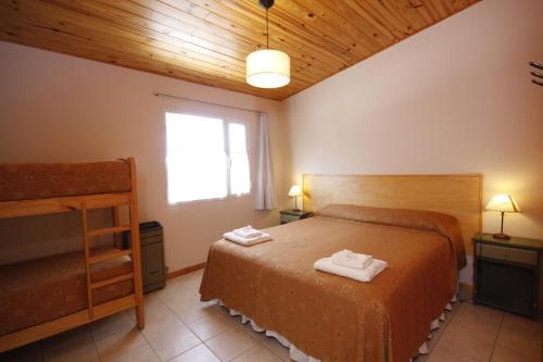 sypialnia z łóżkiem z dwoma ręcznikami w obiekcie El Gualicho Hostel w mieście Puerto Madryn
