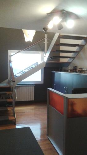 a living room with a loft bed and a tv at Juego Bolos Ostatua in Durango