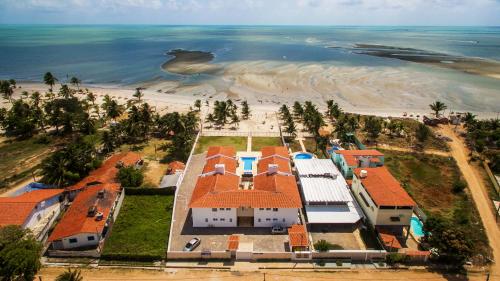 an aerial view of a house and the beach at Manga Verde Beach Residence in Itamaracá