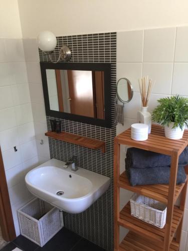 a bathroom with a sink and a mirror at B&B Casa del Fonte in Corinaldo