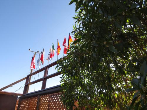 a bunch of flags on top of a building at La Casa de José in San Pedro de Atacama