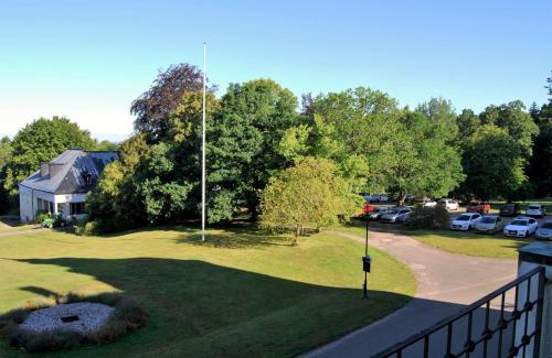 a view of a yard with cars parked in a parking lot at Hellidens Slott in Tidaholm