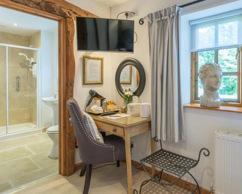 a home office with a desk and a mirror at Blounts Court Farm in Devizes