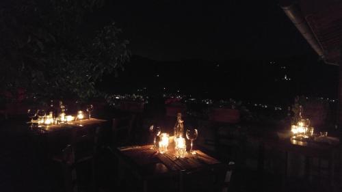 a group of tables with lit candles at night at Agriturismo La Fontaccia in Rufina