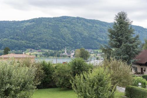 a view of a mountain with a lake and trees at Apartment Sofia in Bodensdorf