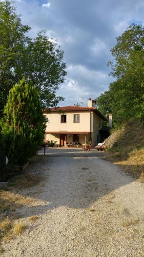 a large house sitting on top of a gravel road at Agriturismo La Fontaccia in Rufina