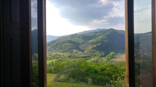 a window with a view of a mountain at Agriturismo La Fontaccia in Rufina