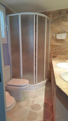 a bathroom with a shower with a toilet and two sinks at Townhouse Mar y Sol in Benalmádena