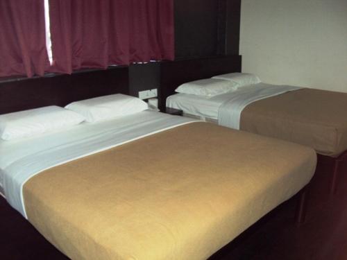 Cama o camas de una habitación en Tai Pan Hotel
